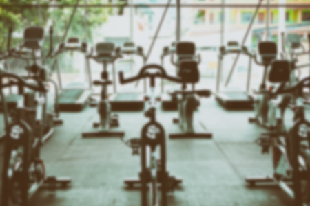 fitness facility center, gym interior, health club with sports training equipment for aerobic exercise workout and bodybuilding, blurry defocused backgroundの写真素材