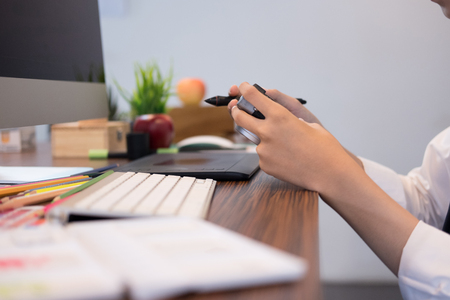 interior designer drawing on graphic tablet at office. artist working with computer at workplace. photographer retouch photo. design, creativity, ideaの写真素材