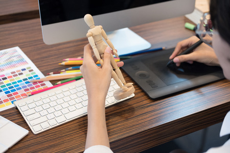 interior designer drawing on graphic tablet at office. artist working with computer at workplace. photographer retouch photo. design, creativity, ideaの写真素材