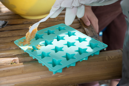 people pour soap into silicone mold. hand making handmade natural soap at home.の写真素材