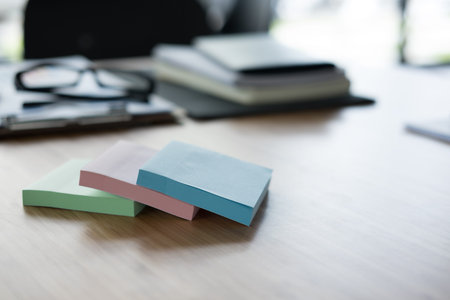 sticky note, eyeglasses, notebook on wood office desk. business, workplace, education concept....