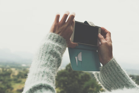 woman use smart phone to take photo of rural landscape in Thailand. forest & mountain in morning....