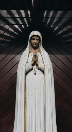 praying virgin mary statue. holy woman sculpture in roman catholic church. our lady imageの写真素材