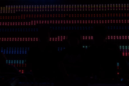 silhouette dj mixing audio music at night club. male sound engineer balancing volume of digital...