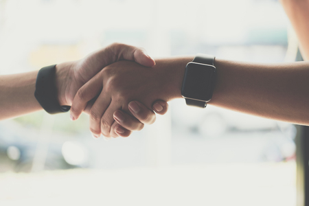 Business people shaking hands after finishing up a meeting. Two colleagues handshaking after conference. Greeting deal, teamwork, partnership, collaboration, corporate concept.の写真素材