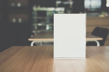 white label in cafe. display stand for acrylic tent card in coffee shop. mockup menu frame on table in bar restaurant. space for textの写真素材
