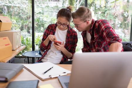 startup small business owner working at workplace. freelanceman & woman seller check product order for delivery to customer.  Online selling, e-commerce, shipping conceptの写真素材