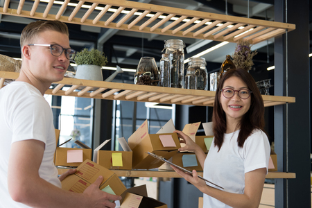 startup small business owner working at workplace. freelance man & woman seller check product order for delivery to customer.  Online selling, e-commerce, shipping conceptの写真素材