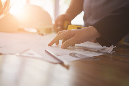 architect working on real estate project with partner at workplace. engineer discussing with colleague on living house blueprint at office.の写真素材
