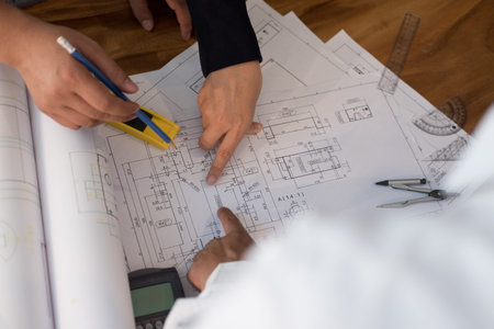 architect working on real estate project with partner at workplace.