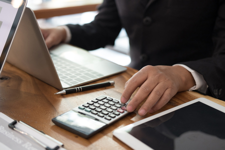 financial adviser working with calculator, business documentの写真素材