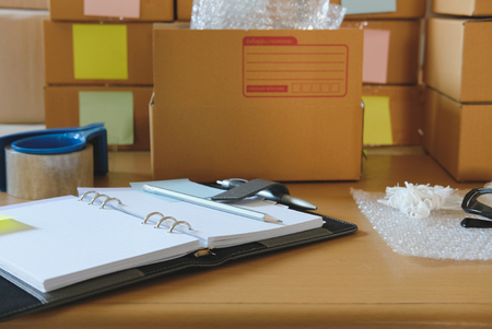 notebook, packing accessories at workplace of startup small business owner.の写真素材