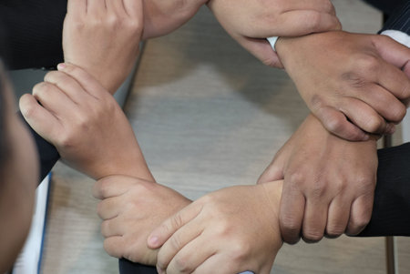 businessman joining united hand, business team holding hands together in circle loop. unity,...