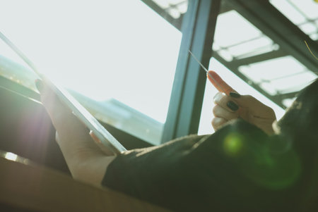 young woman holding a credit card and using tablet for online shopping at cafe. businesswoman purchase goods from internet at office. female adult make payment on bank website at workplaceの写真素材
