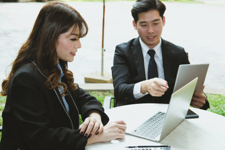 young business people having a meeting. businessman & businesswoman working with computer together...