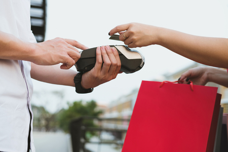 man make payment with credit card swipe through terminal. customer paying & entering code with EDC or swiping machine. buy and sell product or serviceの写真素材