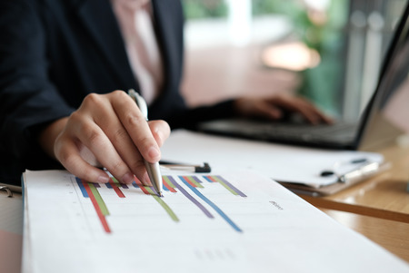 asian businesswoman using computer at cafe. startup woman working with laptop at office. young female entrepreneur analyze financial data at workplace.の写真素材