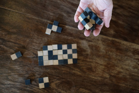 cubic wood block puzzle game. education and leisure concept. growth, success & development in...