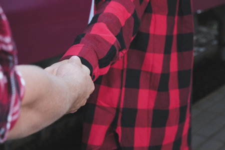 young couple in love holding hands. boyfriend & girlfriend dating in valentine's day. man & woman walking outdoor. relationship, lover lifestyle conceptの写真素材