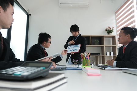 business people having a meeting. businessman working with financial plan report. startup man discussing idea at workplace. teamwork, corporate concept.の写真素材