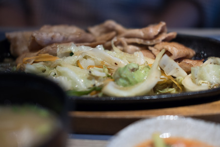 grilled barbecue pork slices & fried vegetable. japanese food in restaurantの写真素材