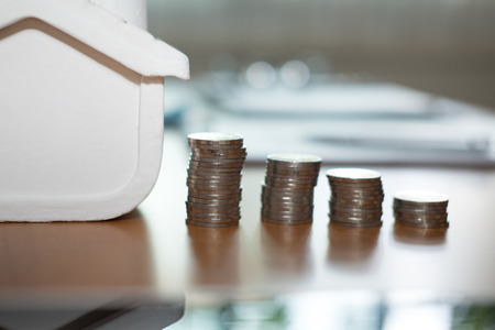 coin stack and house model. plan for property purchase. mortgage loan, real estate investment conceptの写真素材