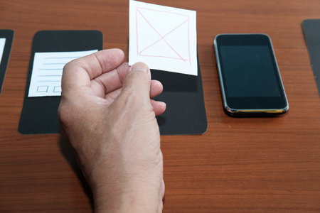 user experience (UX) designer designing web on smart phone layout. UI planning mobile application....