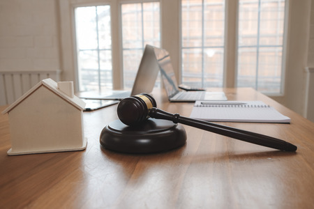judge gavel & house model at courtroom. estate law & property auction conceptの写真素材