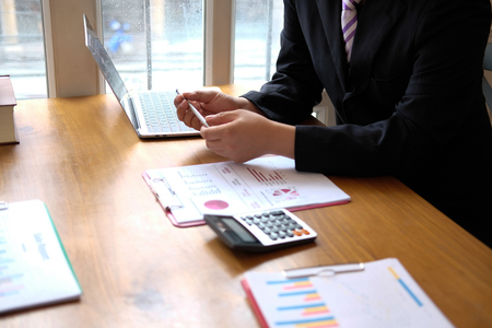 business adviser analyzing company financial report. professional investor reviewing performance revenue. businessman working on startup projectの写真素材