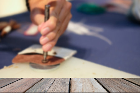 craftsman pinching button on leather bag. handmade DIY handicraft workshop