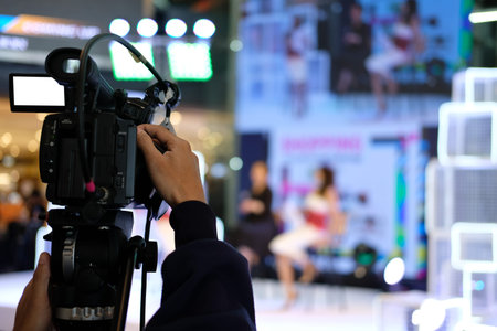 professional video production camera recording live event on stage. television social media...