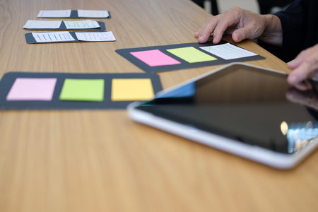 user experience workplace. UX designer desk with tablet layout. UI planning mobile application.