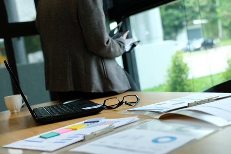 man organizing plan with notebook & smart phone. businessman working  at workplace coworking officeの写真素材