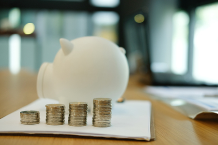 coin & white piggy bank. money savings, cash deposit conceptの写真素材
