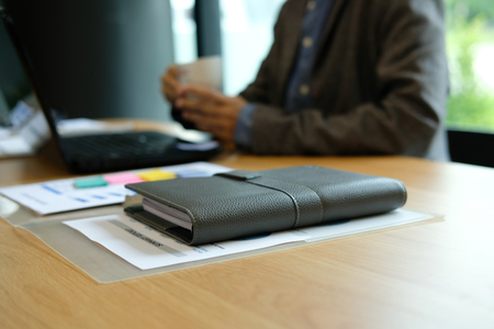 businessman with coffee cup working at workplace coworking office.の写真素材