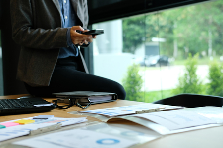 businessman using smart phone at workplace. startup man working at office.  male entrepreneur with mobile phone.の写真素材