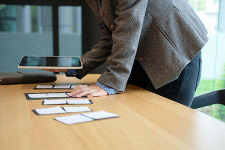 user experience workplace. UX designer desk with tablet layout. UI planning mobile application.の写真素材