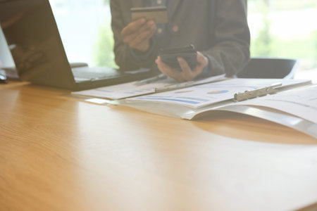 man holding credit card using smart phone for online shopping. businessman purchase product from...