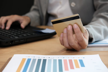 woman holding credit card using computer for online shopping. businesswoman purchase product from...