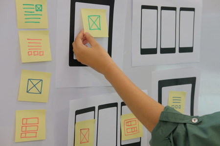 user experience, UX designer designing web on smart phone tablet layout. UI planning mobile...