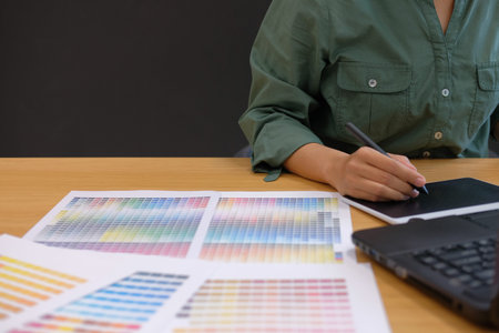 graphic interior designer working with computer. creative man drawing with digital tablet & stylus...
