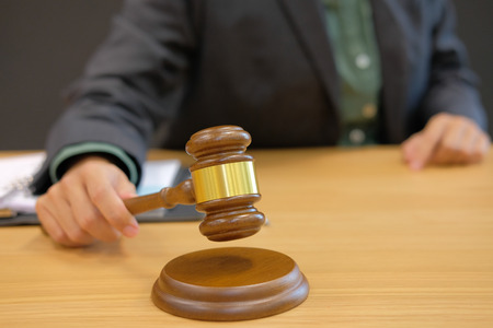 judge holding legal law gavel at courtroom. lawyer attorney justice at courtの写真素材