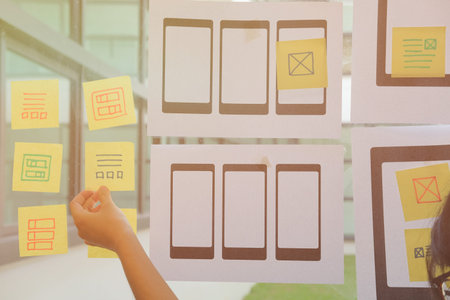 user experience, UX designer designing web on smart phone tablet layout. UI planning mobile...