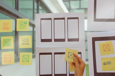 user experience, UX designer designing web on smart phone tablet layout. UI planning mobile application. developer work with business prototypeの写真素材