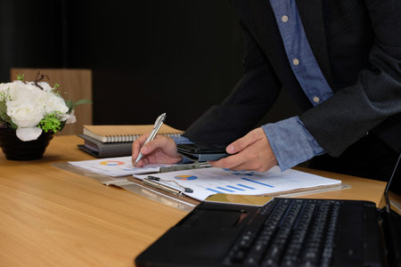 man working organizing plan with smart phone. businessman analyzing document at workplace coworking...