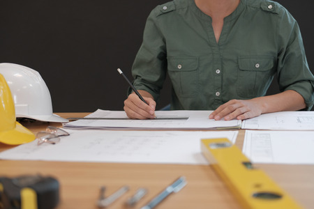 architect engineer working on house blueprint of real estate project at workplace. construction & building conceptの写真素材