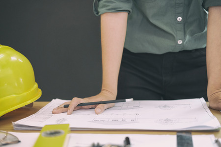 architect engineer working on house blueprint of real estate project at workplace. construction & building conceptの写真素材