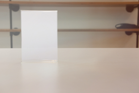 white label in cafe. display stand for acrylic tent card in coffee shop. mockup menu frame on table in restaurant. space for textの写真素材