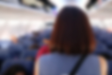 passenger in airplane. aeroplane interior. blurry defocused backgroundの写真素材