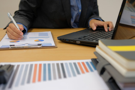 businessman using computer. startup man working with document at office. male entrepreneur analyze financial data at workplace.の写真素材